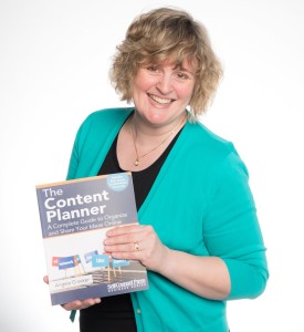 Angela Crocker holding a copy of her book, The Content Planner.